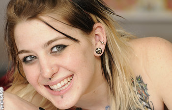 smiling attractive blond haired woman with piercing